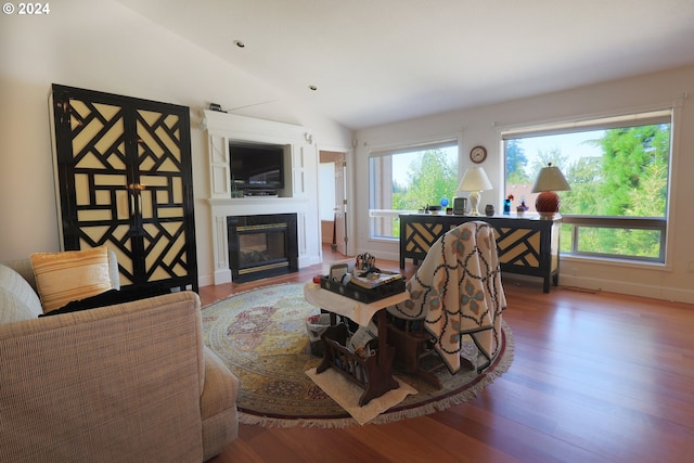 living room with vaulted ceiling and hardwood / wood-style flooring