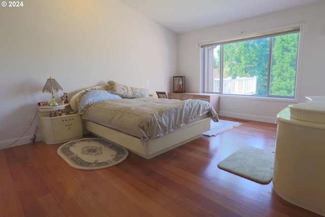 bedroom with hardwood / wood-style floors