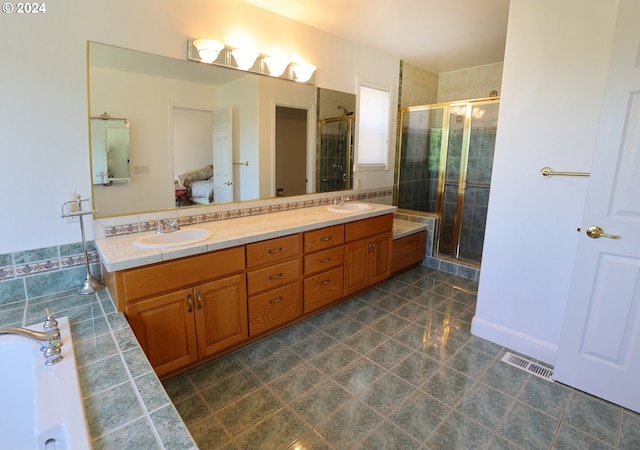 bathroom with vanity and a shower with shower door