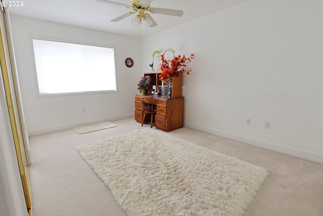 bedroom featuring light colored carpet and ceiling fan