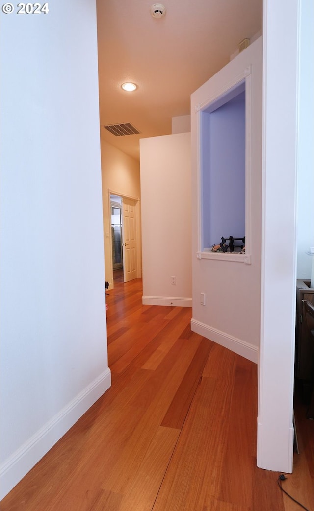 corridor with light hardwood / wood-style flooring