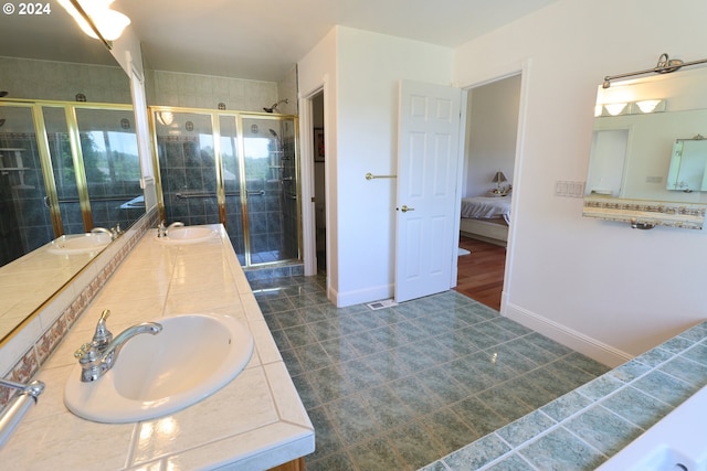 bathroom featuring tile patterned floors, vanity, and an enclosed shower