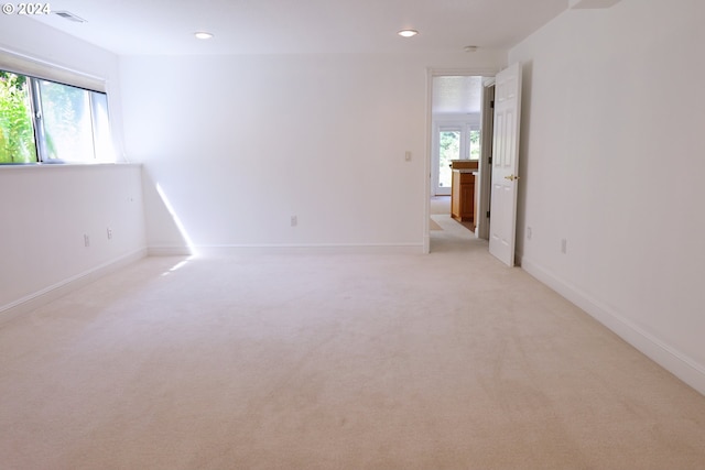 empty room with a wealth of natural light and light carpet