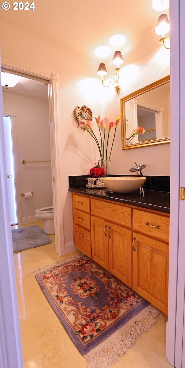 bathroom featuring tile patterned floors, vanity, and toilet