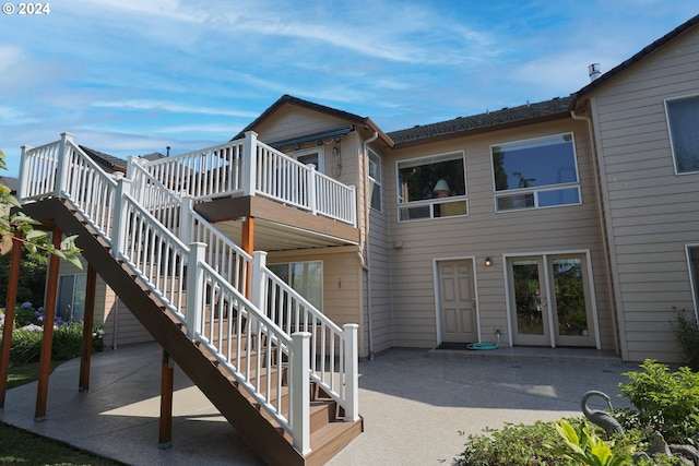 back of property featuring a patio area and a deck