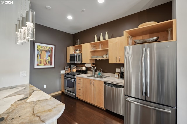 kitchen featuring decorative light fixtures, open shelves, appliances with stainless steel finishes, a sink, and light stone countertops