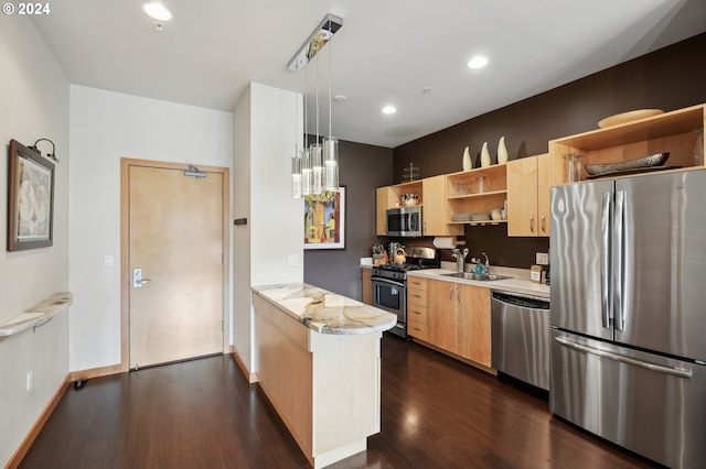 kitchen featuring light stone counters, a sink, appliances with stainless steel finishes, open shelves, and decorative light fixtures