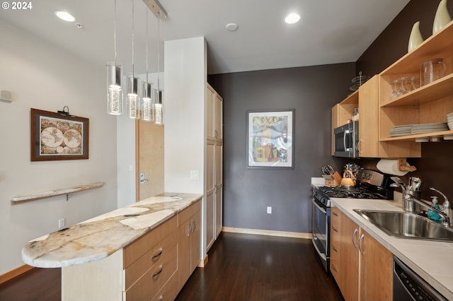 kitchen featuring appliances with stainless steel finishes, decorative light fixtures, a peninsula, open shelves, and a sink