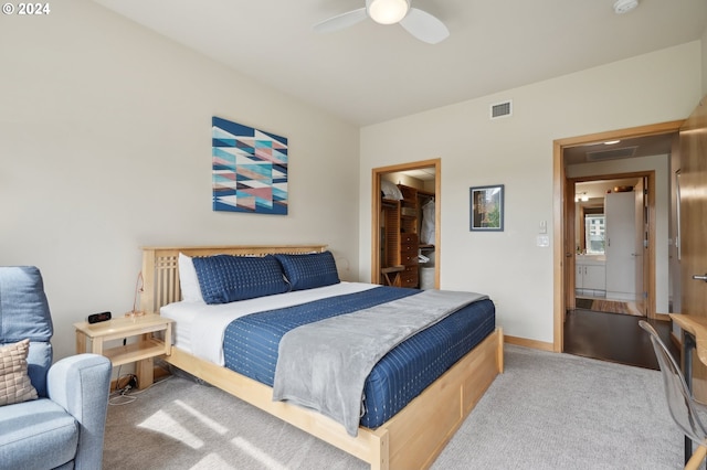 carpeted bedroom featuring a ceiling fan, visible vents, and baseboards