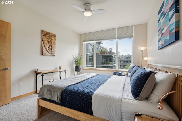 carpeted bedroom with ceiling fan and baseboards