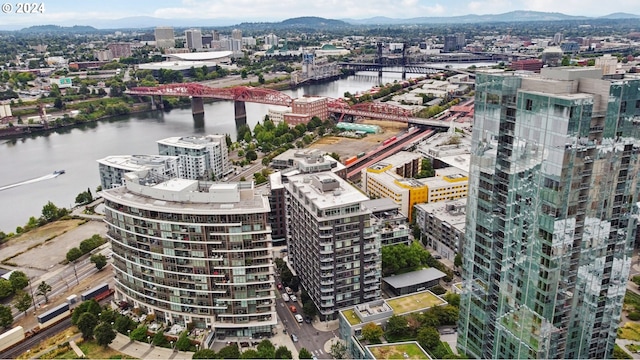 aerial view featuring a view of city and a water and mountain view