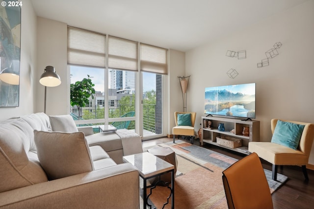 living room featuring a wall of windows and hardwood / wood-style floors