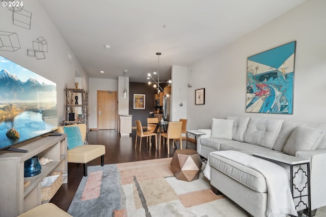 living room featuring an inviting chandelier and wood finished floors