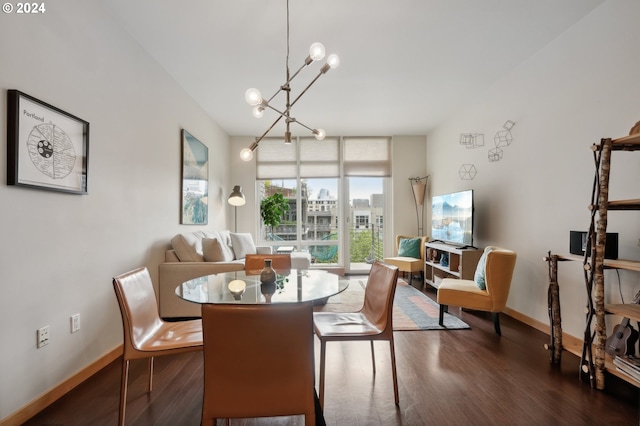 dining area featuring a chandelier, dark wood-type flooring, and baseboards