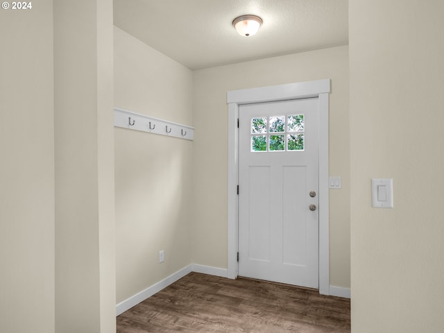 interior space with a textured ceiling and hardwood / wood-style floors