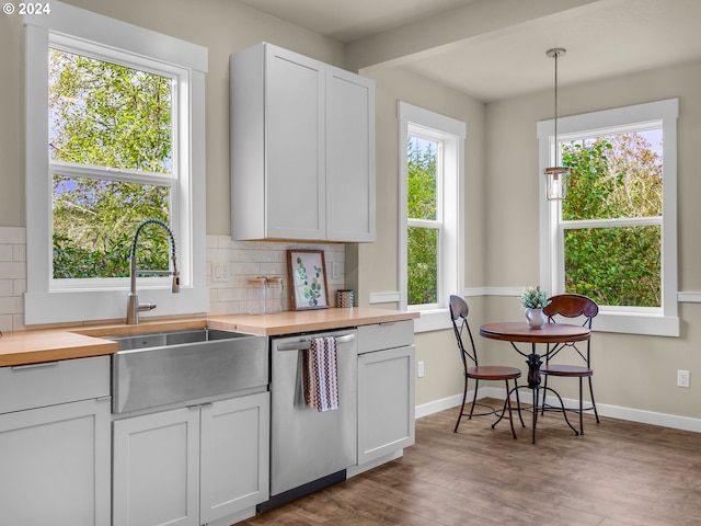 kitchen featuring backsplash, white cabinetry, dishwasher, and pendant lighting