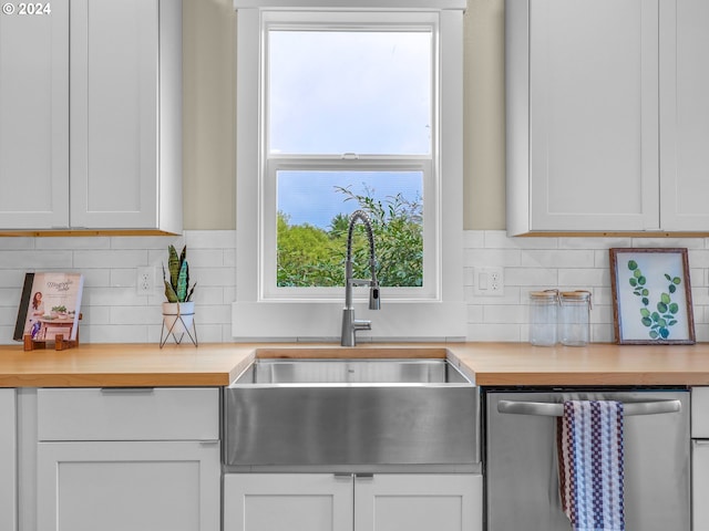 kitchen featuring sink, white cabinetry, dishwasher, and wood counters