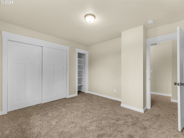 unfurnished bedroom featuring light carpet