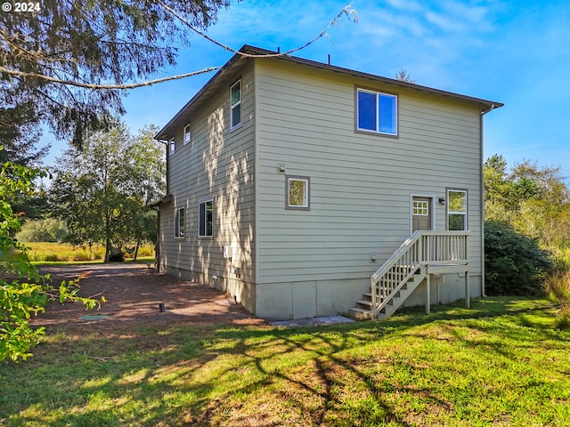 rear view of property with a lawn