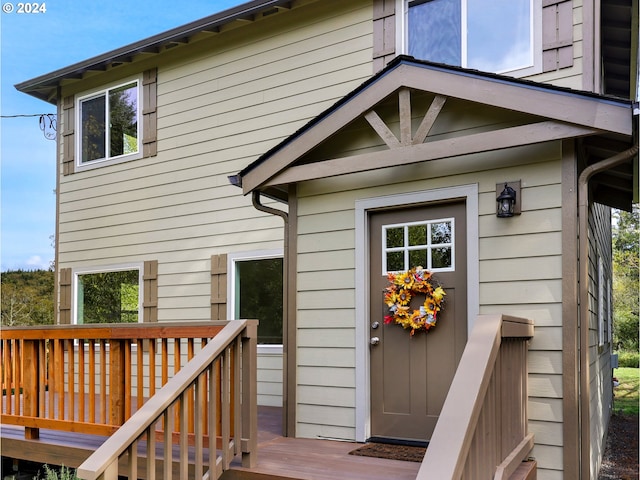 view of exterior entry featuring a wooden deck