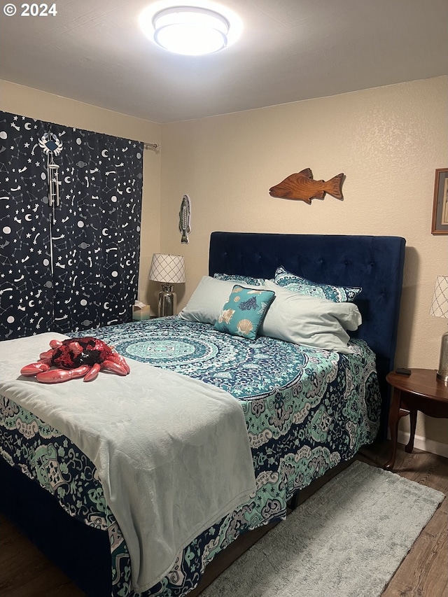 bedroom with hardwood / wood-style flooring