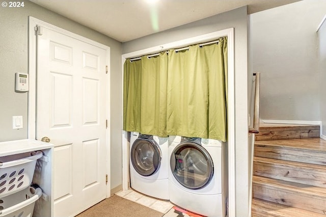 laundry area with washer and dryer and light tile patterned floors