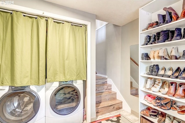 laundry area with separate washer and dryer and light hardwood / wood-style flooring