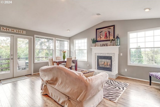 living room featuring french doors, vaulted ceiling, and a wealth of natural light