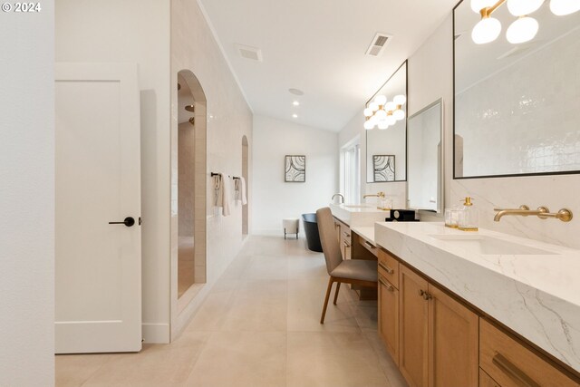 23141 SW Curry Ridge Dr, Sherwood, OR 97140 - bathroom with two vanities, tile patterned flooring, a tile shower, vaulted ceiling, and a freestanding bath