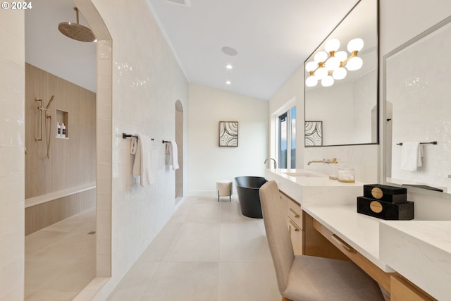 bathroom with walk in shower, vanity, lofted ceiling, and tile patterned flooring