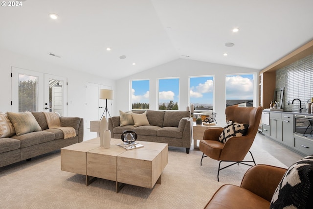 living room featuring french doors and vaulted ceiling