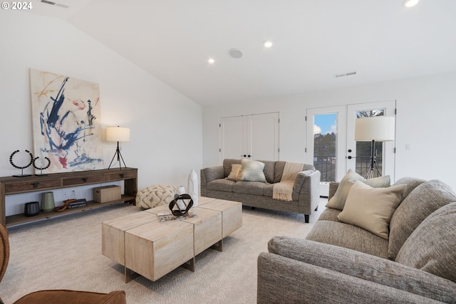 carpeted living room with lofted ceiling and french doors