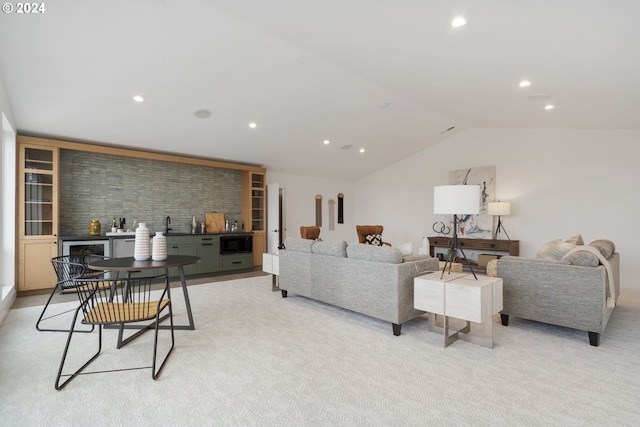 living room featuring light colored carpet, lofted ceiling, and indoor bar