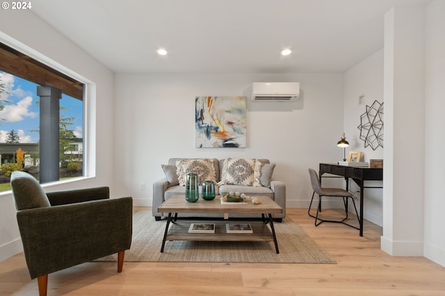 living room featuring a wall mounted AC and light hardwood / wood-style flooring