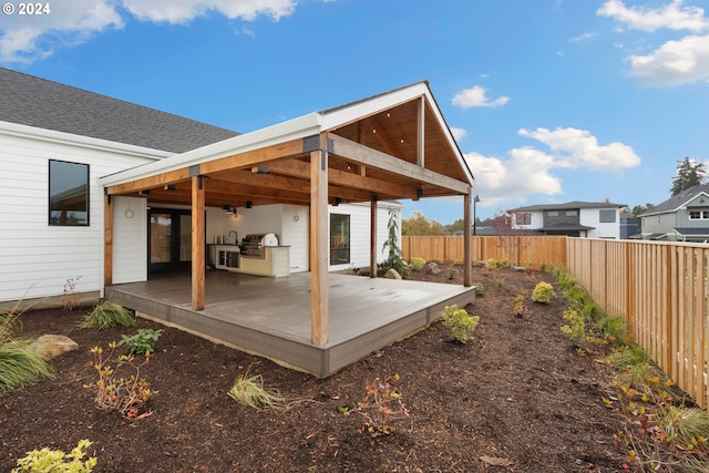23141 SW Curry Ridge Dr, Sherwood, OR 97140 - rear view of property featuring a fenced backyard, a wooden deck, and an outdoor kitchen