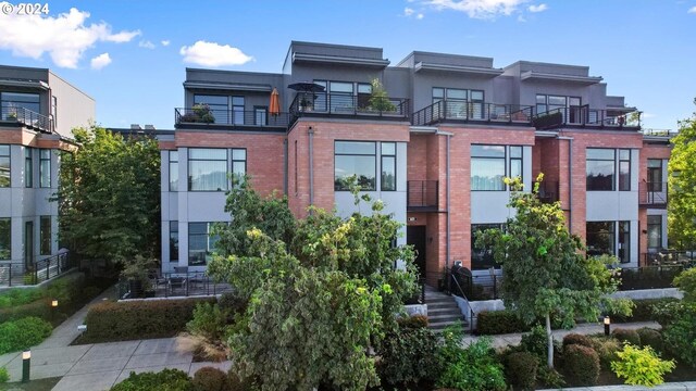 view of front of house featuring a balcony