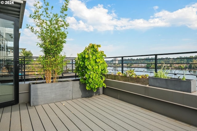 wooden deck featuring a water view