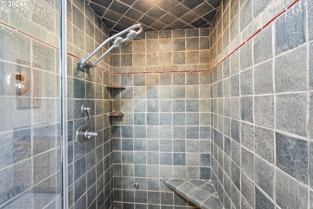 bathroom with a tile shower