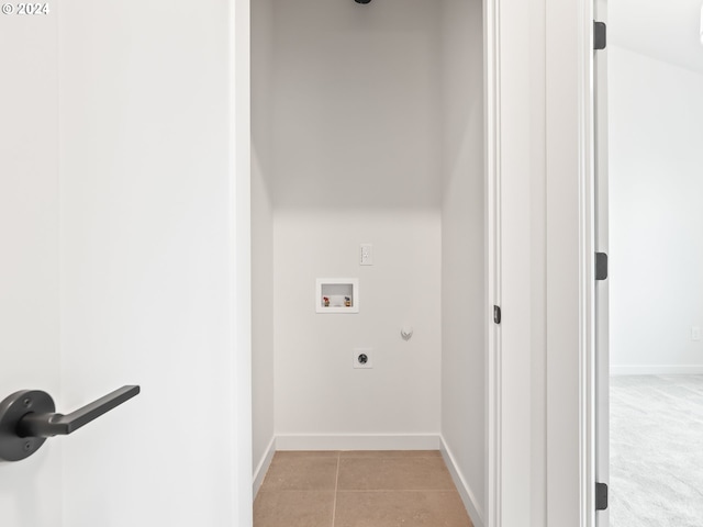 clothes washing area featuring light tile patterned floors, baseboards, hookup for a gas dryer, hookup for a washing machine, and hookup for an electric dryer