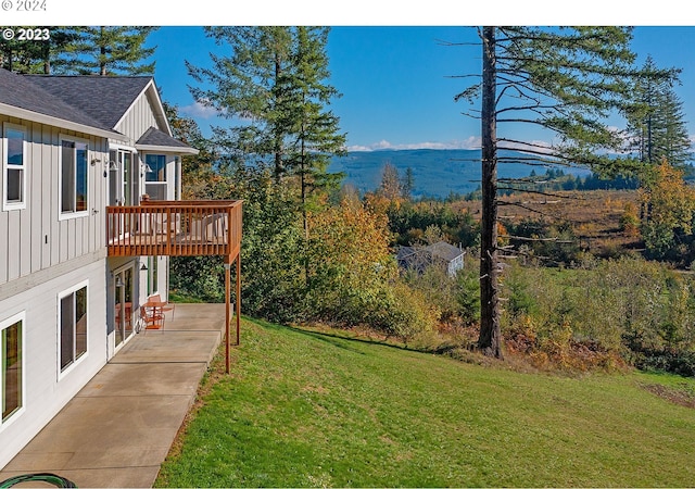 view of yard with a patio area and a wooden deck