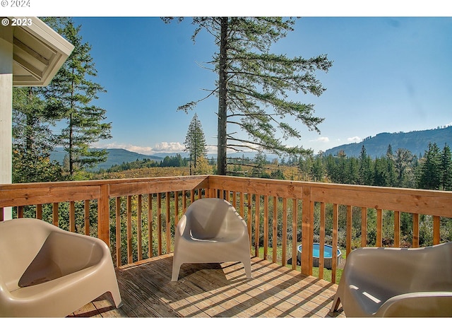 deck with a mountain view and area for grilling