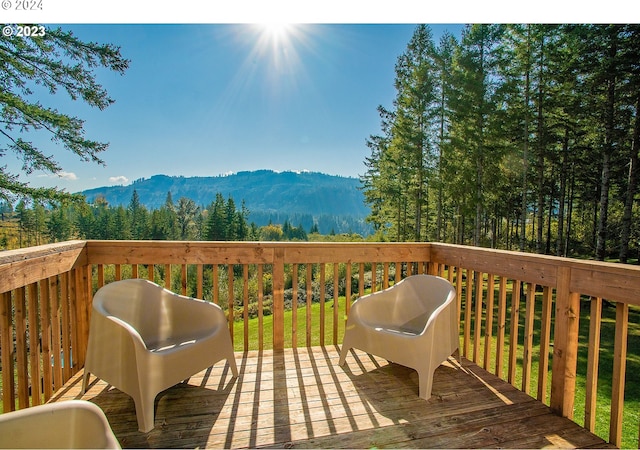 wooden terrace featuring grilling area and a mountain view