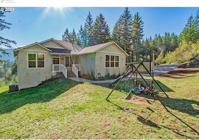 ranch-style home with a front yard and central air condition unit