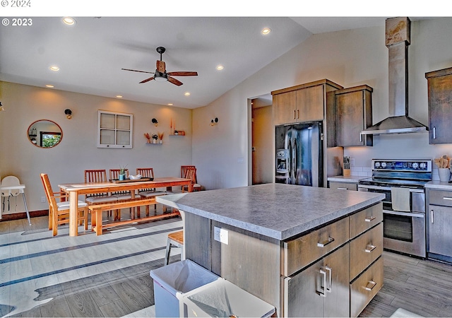 kitchen featuring a center island, wall chimney exhaust hood, light hardwood / wood-style floors, stainless steel electric range, and black fridge with ice dispenser