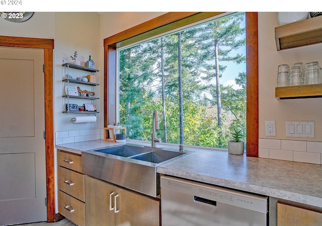 kitchen with dishwasher, decorative backsplash, and sink