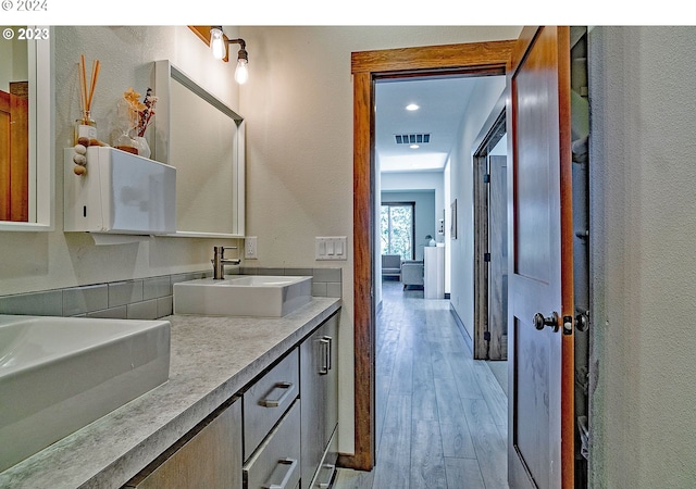 bathroom with hardwood / wood-style floors and vanity