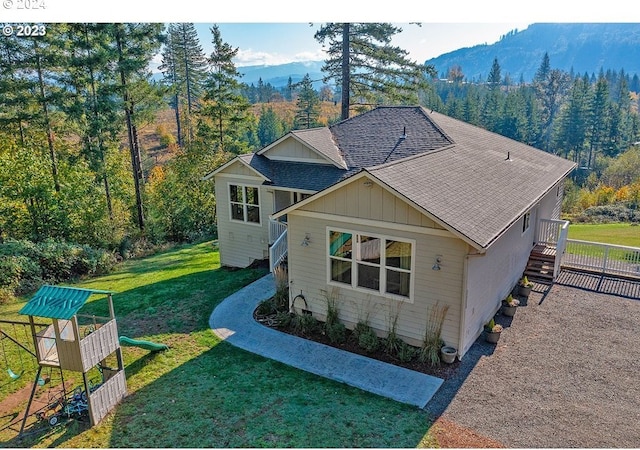 exterior space featuring a mountain view and a yard