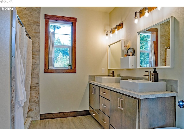 bathroom with curtained shower, hardwood / wood-style floors, and vanity