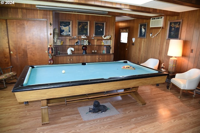 recreation room featuring wood walls, wood-type flooring, an AC wall unit, and pool table