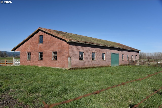 view of side of property with a lawn